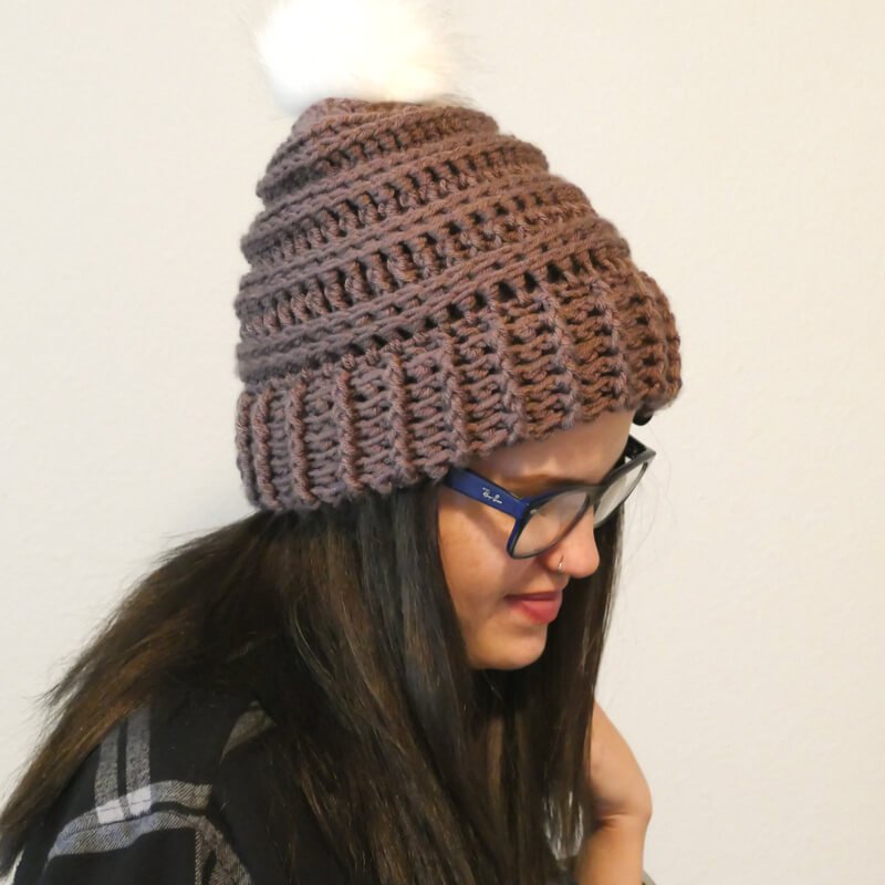 Photo of a woman wearing the crocheted Keystone Ribbed Hat