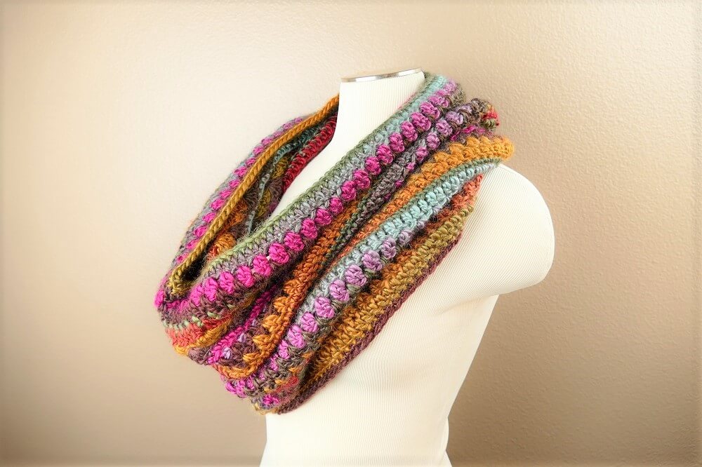 Image of the multicolored crochet hooded cowl on a mannequin 