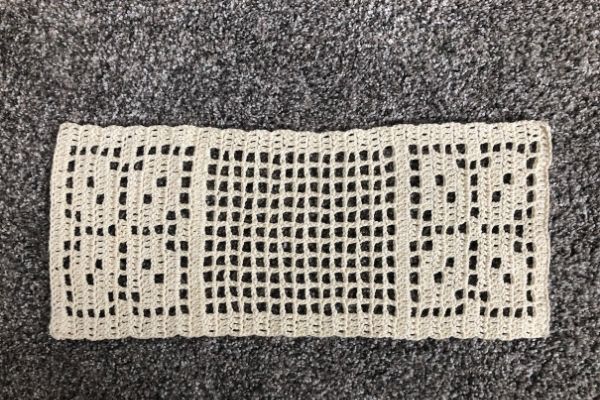 Image of an unblocked autumn leaves filet crochet table runner