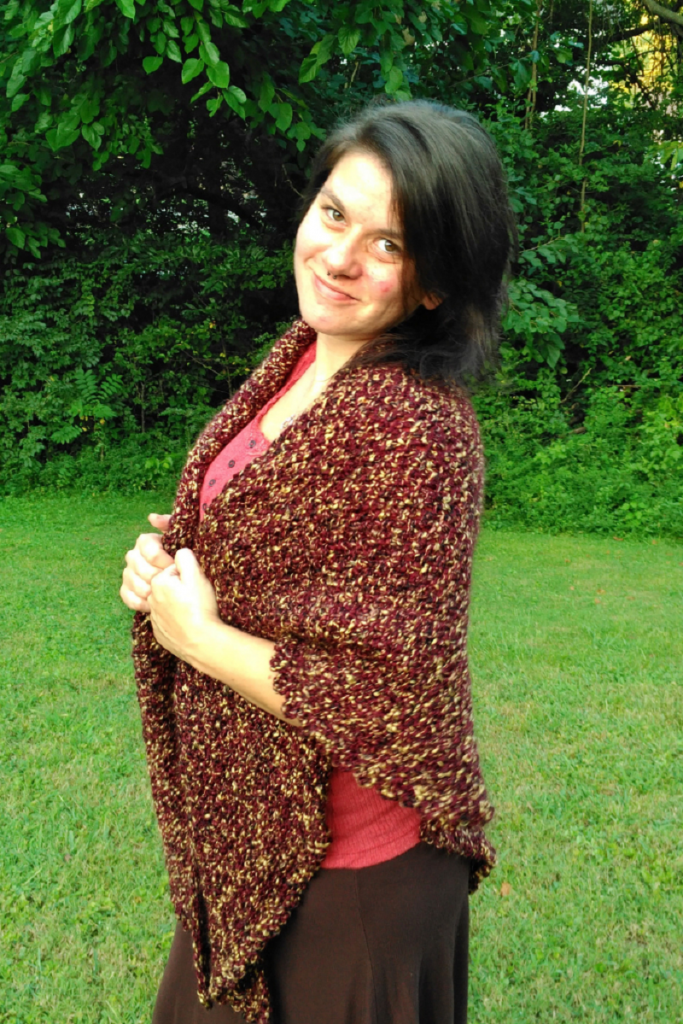 Photo of Chantal modeling the crochet Homebody triangle shawl